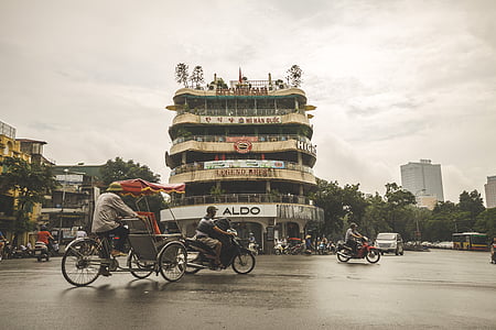 man riding trike near building thumbnail
