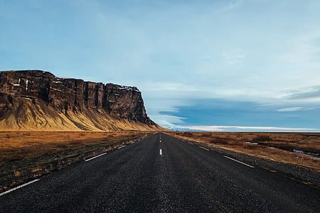 rocky mountain near asphalt road during daytime thumbnail