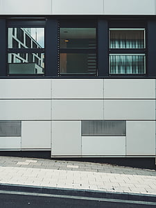 white and black concrete building near road at daytime thumbnail