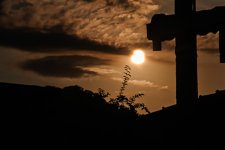 silhouette of cross on top of roof thumbnail