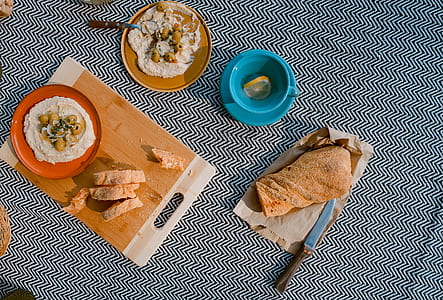 brown wooden chopping board beside blue ceramic teacup thumbnail