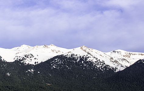 mountain covered by snow at cloudy sky during daytime thumbnail