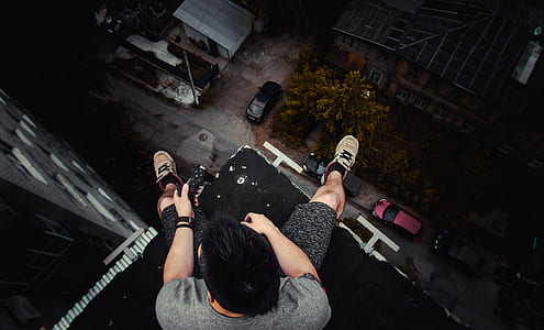 man sitting on ledge thumbnail