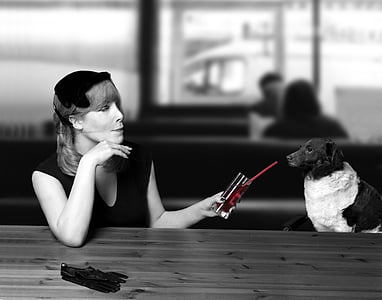 grayscale photo of woman and dog thumbnail