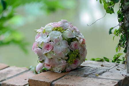 pink and white rose bouquet on brown bricks thumbnail