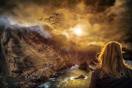blonde haired woman with black shirt facing brown mountain during sunrise thumbnail