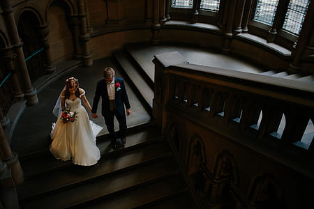 wedding couple walking on stairs holding hands thumbnail