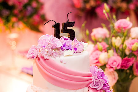 white and pink birthday cake near pink flowers thumbnail