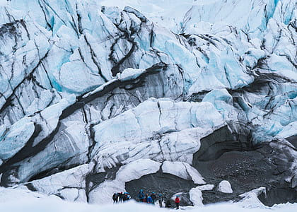 people standing near white rock formation at daytime thumbnail