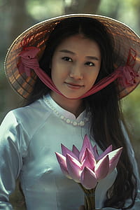 woman in white dress and brown wicker hat thumbnail