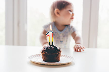 baby in front of chocolate cupcake thumbnail