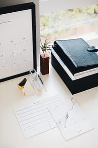 clear acrylic tape dispenser beside ballpoint pen on white table thumbnail