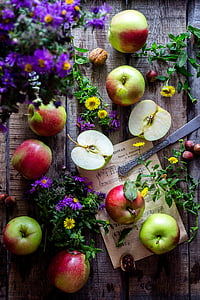 apples and flowers on table thumbnail