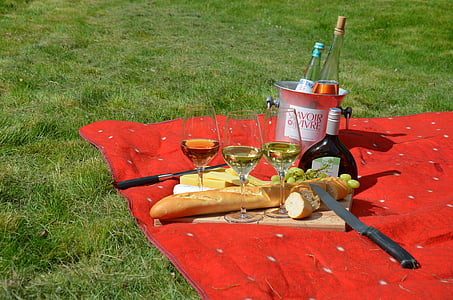 three clear long-stemmed wine glasses and bread on red textile thumbnail
