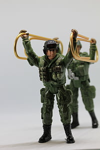 two soldier toys holding two gold paper clips thumbnail