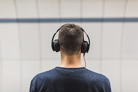selective focus photo of man wearing black headphones thumbnail