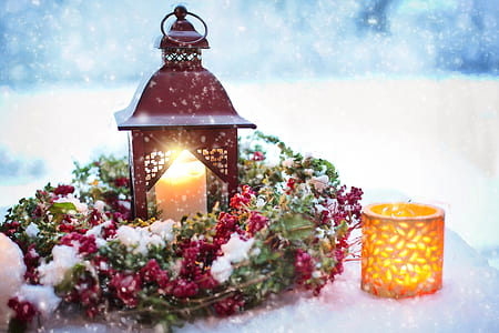 white pillar candle in red lantern during winter thumbnail