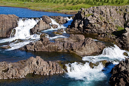 brown rocks in body of water thumbnail