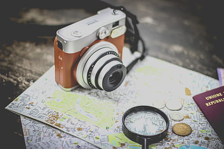 silver and brown camera near black magnifying glass thumbnail