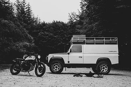 white classic motorcycle and white off-road truck in greyscale photography thumbnail