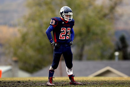football player standing on grass thumbnail