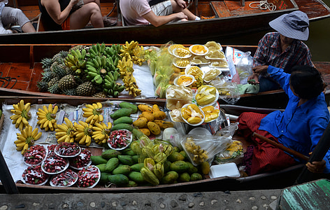 assorted fruits on boats at daytime thumbnail