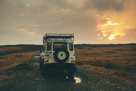 white vehicle between yellow grass field thumbnail