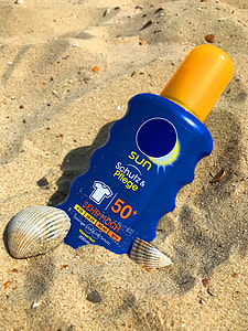 blue and yellow plastic bottle on the sand thumbnail