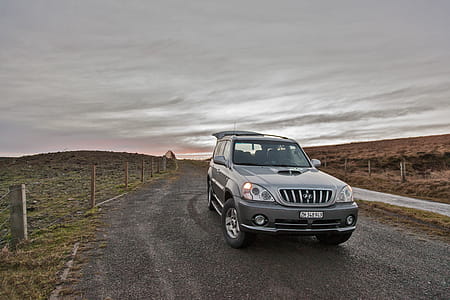 Gray Hyundai Suv Under Cloudy Sky thumbnail