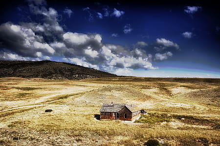 aerial photography of brown house under blue cloudy sky thumbnail