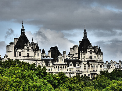 black and white castle near green tress under cloudy sky during daytime thumbnail