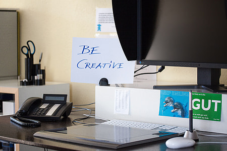 Be Creative written on white paper near black flat screen monitor and black IP phone thumbnail