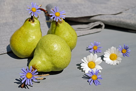 three yellow fruits and white and purple petaled flowers at daytime thumbnail