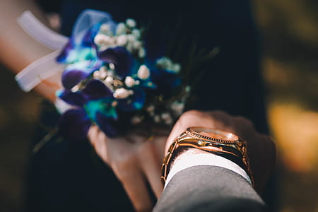 selective focus photography of man's gold-colored watch thumbnail