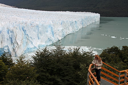 woman standing near body of water during daytime thumbnail