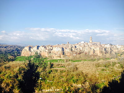 brown concrete houses on hill at daytime thumbnail