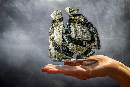 person's hand with rock floating over illustration thumbnail