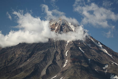 low-angle photography of brown and white mountain at daytime thumbnail