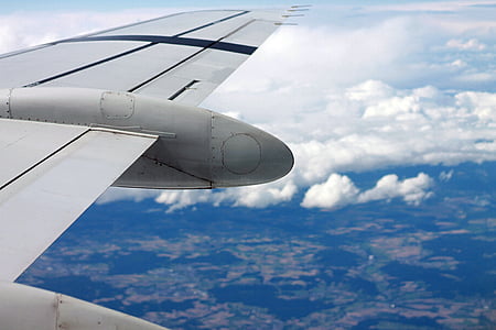 white airplane flying over clouds at daytime thumbnail