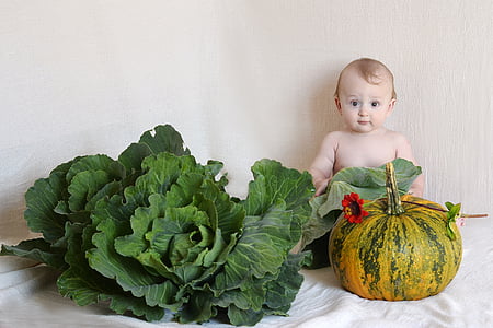 baby in front of cabbage and squash thumbnail