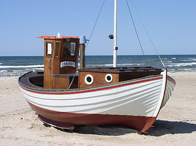 White and Brown Speedboat on White Sand Beside Ocean during Daytime thumbnail