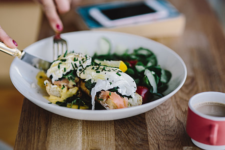 Close up image of young woman eating classic breakfast at restaurant thumbnail