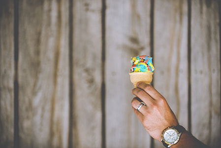 person holding ice cream cone with ice cream thumbnail