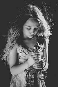 greyscale photo of girl wearing sleeveless dress and holding sword thumbnail