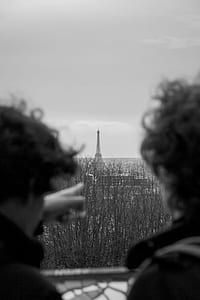 grayscale photo of two person facing Eiffel Tower thumbnail