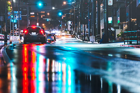 several cars beside street during night time thumbnail