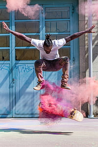 man wearing white shirt skateboarding with pink powder effects thumbnail