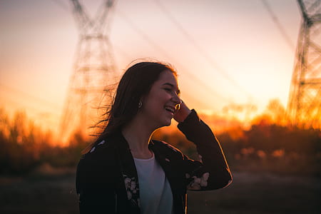 woman laughing at someone during sunset thumbnail