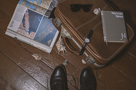 brown leather suitcase beside shoes thumbnail