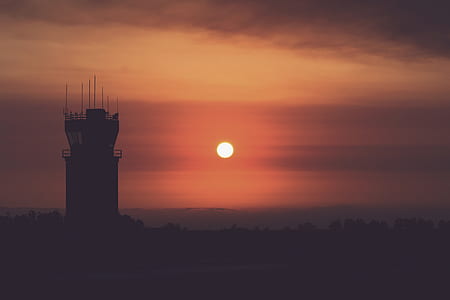 silhouette photography of tower during sunset thumbnail